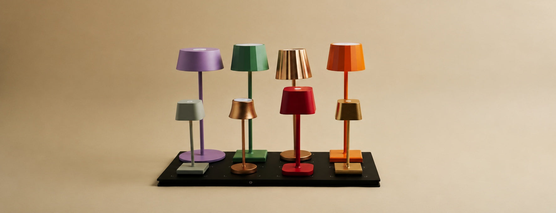Tavellio, eight colorful wireless table lamps arranged on a single central magnetic charging station.