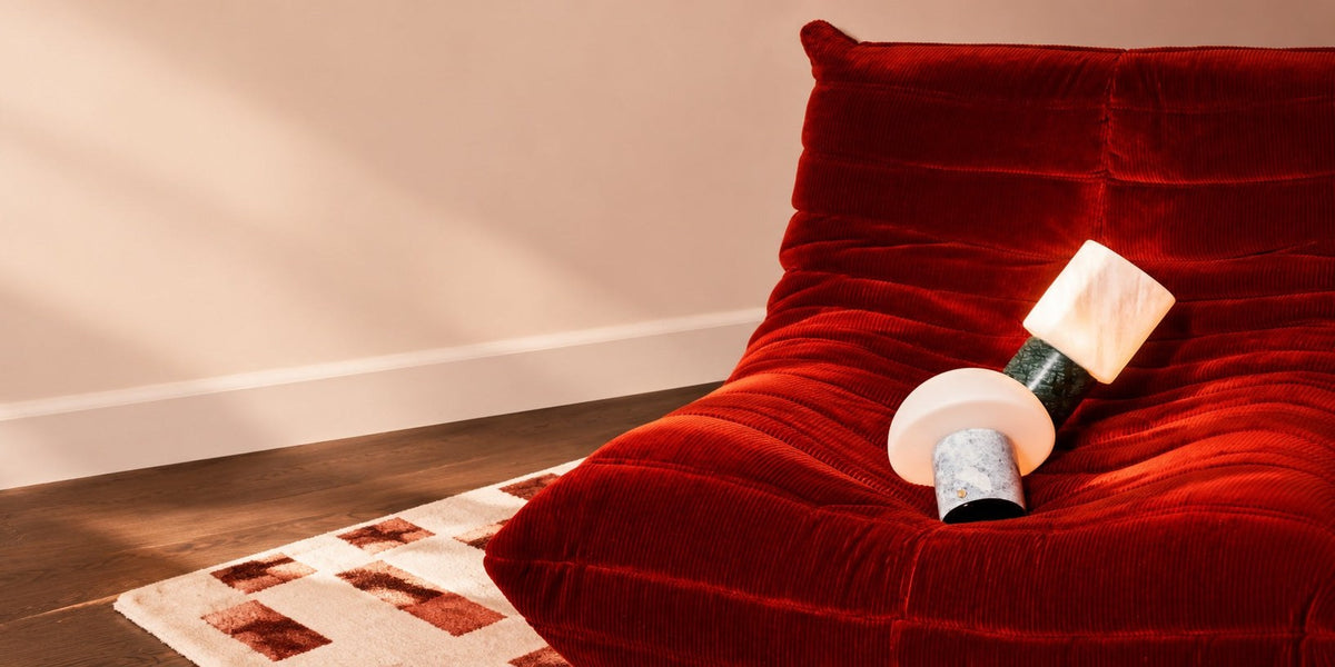 Modular rechargeable table lamps with stone bases and different shades grouped together