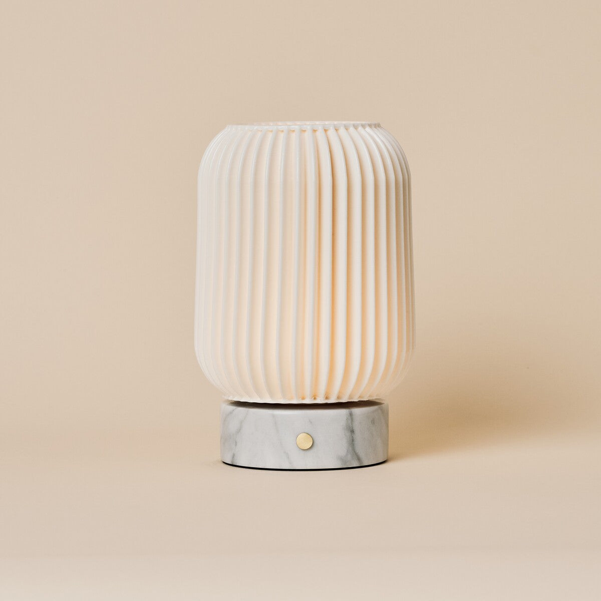 Alba rechargeable table lamp with Bianco Statuarietto white marble base and fluted porcelain shade on beige
