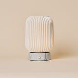 Alba rechargeable table lamp with Bianco Statuarietto white marble base and fluted porcelain shade on beige