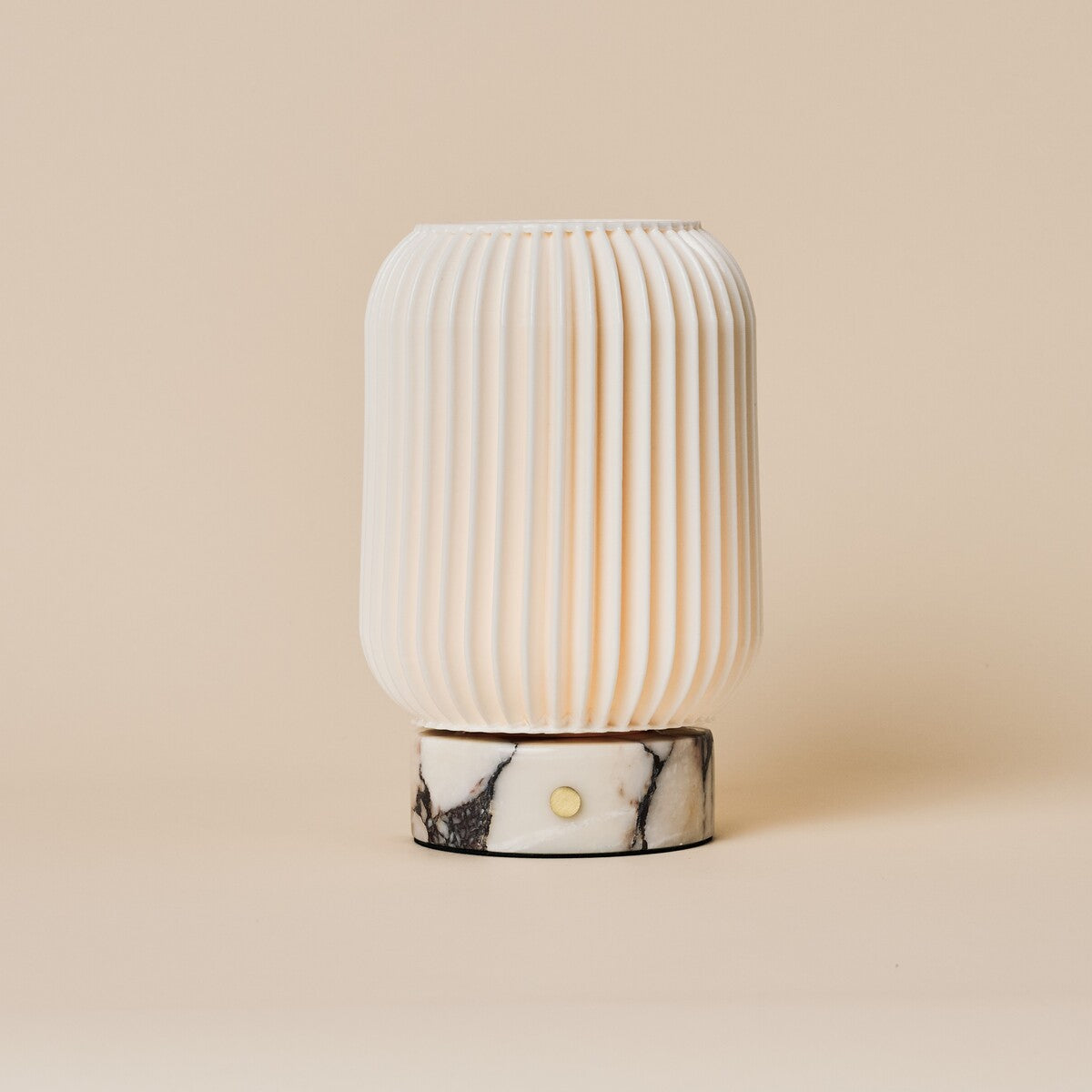 Alba cordless table lamp with Calacatta Vionaro marble base on a beige studio backdrop