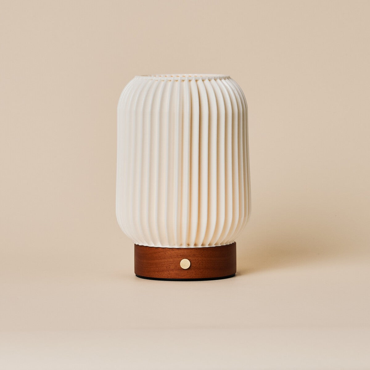 Rechargeable table lamp Alba in chestnut brown wood with fluted porcelain shade on a beige backdrop