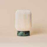 Cordless table lamp Alba with Ice Green marble base and ribbed porcelain shade on a beige backdrop