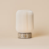 Cordless table lamp Alba in silver travertine and porcelain, fluted shade viewed straight-on