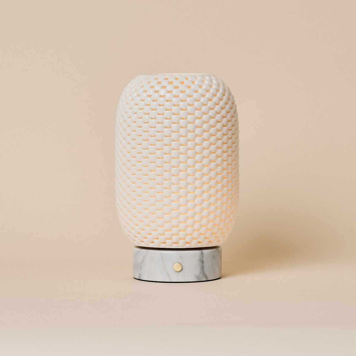 Tavellio Aurora rechargeable table lamp with dimpled porcelain shade and Bianco Statuarietto marble base, studio shot