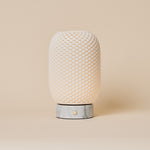 Tavellio Aurora rechargeable table lamp with dimpled porcelain shade and Bianco Statuarietto marble base, studio shot