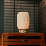 Aurora cordless table lamp in yellow Calacatta Vionaro marble lit beside striped window blinds