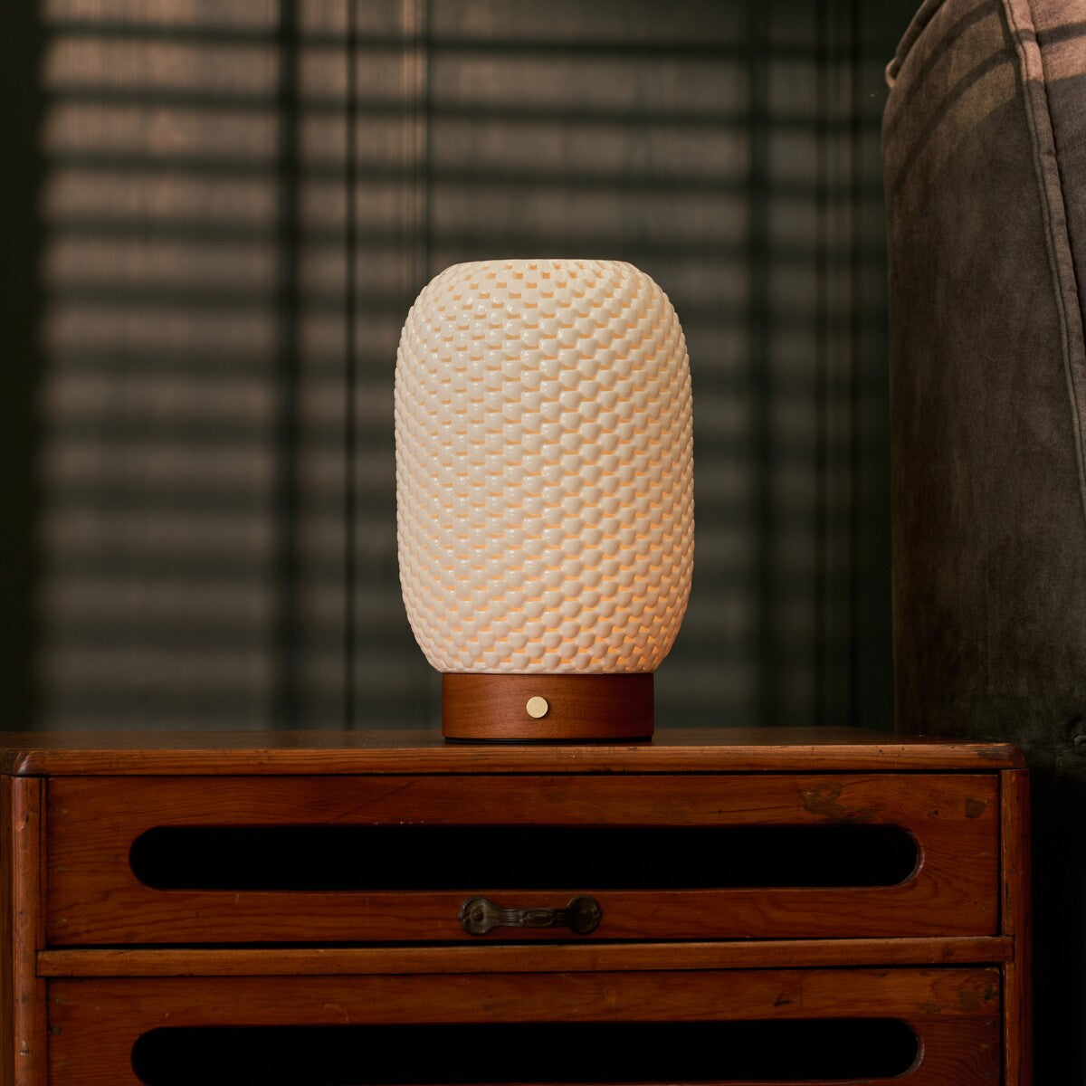 Aurora Chestnut Brown cordless lamp on a bedside table near blinds and a striped armchair