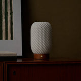 Aurora Chestnut Brown rechargeable lamp unlit, its textured porcelain shade on a dark wood cabinet