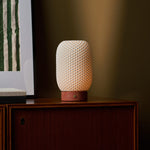 Tavellio Aurora rechargeable table lamp in Red Travertine and porcelain on a beige backdrop