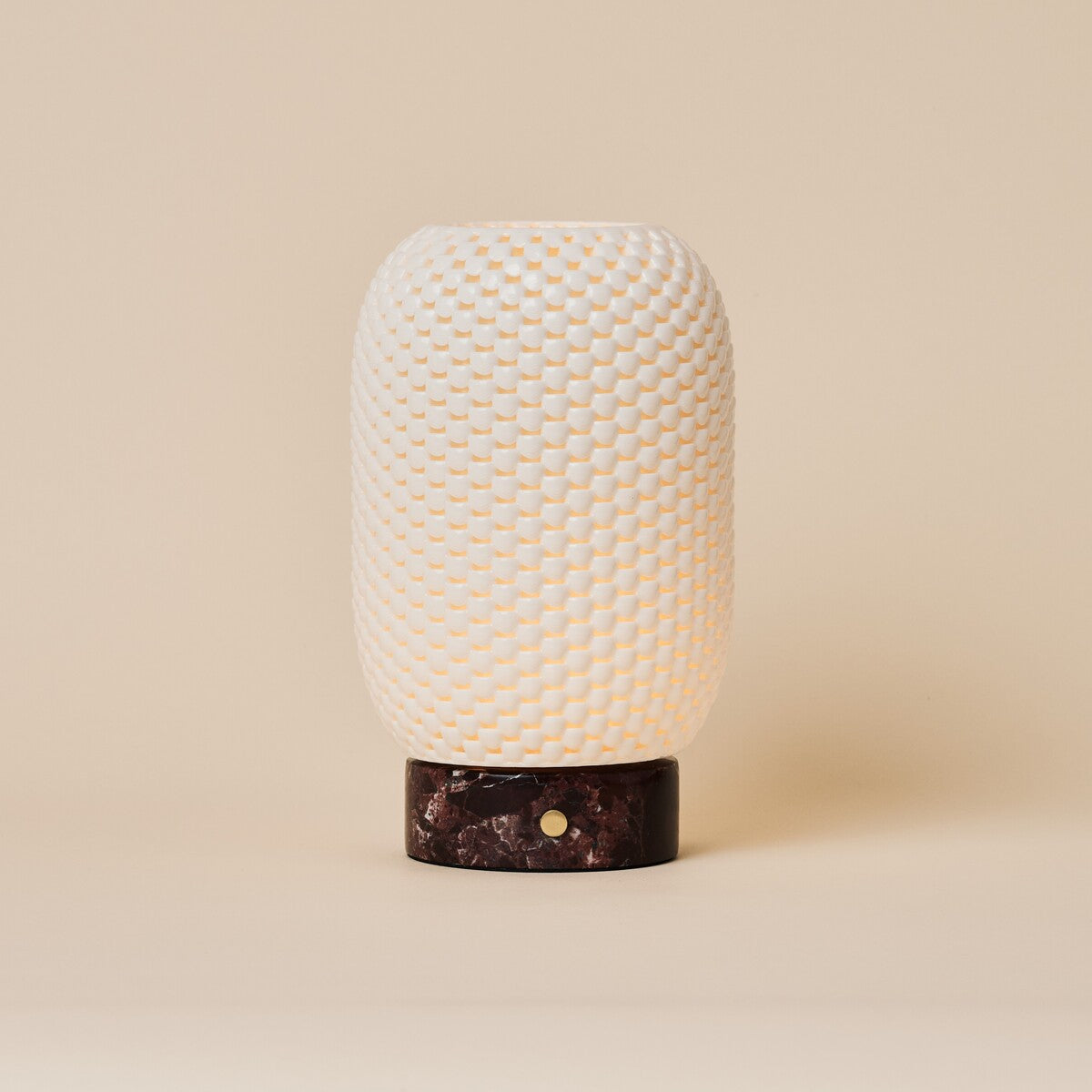 Aurora rechargeable table lamp with woven porcelain shade on a deep red Rosso Levanto marble base