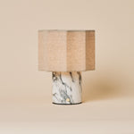 Bonnard rechargeable table lamp in Arabescato marble with a striped linen shade on a beige backdrop