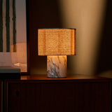 Tavellio Bonnard rechargeable table lamp casting warm light on a wooden sideboard at dusk