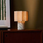 Bonnard rechargeable table lamp on a wood cabinet against an olive wall with striped green artwork