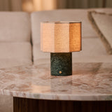 Bonnard green marble rechargeable table lamp with striped linen shade on a marble side table