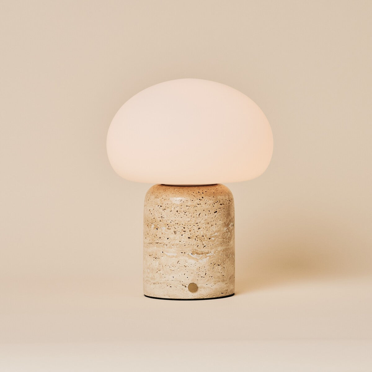Oplaadbare tafellamp Coddé Large in beige travertijn, studiofoto op neutrale achtergrond