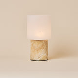 Cuyp Honey Onyx Marble Rechargeable Table Lamp glowing on a cream studio backdrop