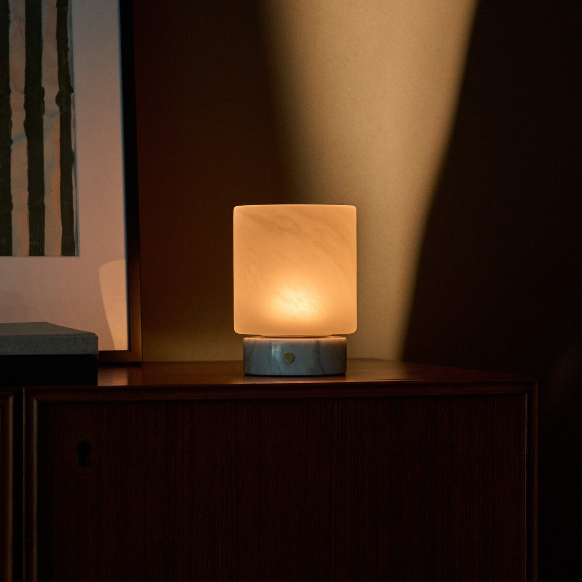 Tavellio Cuyp Small rechargeable table lamp in Bianco Statuarietto marble beside framed wall art