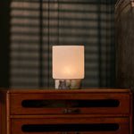 Rechargeable table lamp Cuyp Small, Calacatta Viola marble, lit atop an antique wooden dresser