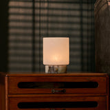 Rechargeable table lamp Cuyp Small, Calacatta Viola marble, lit atop an antique wooden dresser