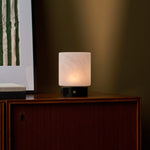 Cuyp cordless table lamp with Nero Marquina base on a wood cabinet against an olive green wall