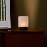 Cuyp cordless table lamp with Nero Marquina base on a wood cabinet against an olive green wall