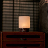 Cuyp cordless table lamp with Rosso Levanto base on a nightstand under venetian blind shadows