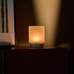 Tavellio Cuyp Small rechargeable table lamp close-up showing its frosted shade and travertine base