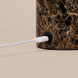 Close-up of the Keyser rechargeable table lamp's charging cable set into Emperador dark marble