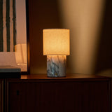 Tavellio Dou rechargeable table lamp in Arabescato marble on a dresser corner at dusk