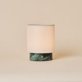 Rechargeable table lamp Dou Small in Ice Green marble with natural linen shade on beige backdrop