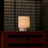Dou Small rechargeable table lamp in Rosa Aurora marble on a vintage dresser with blind-shadow light