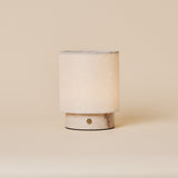 Dou Small cordless table lamp in Rosa Aurora marble with pale pink veining on a plain backdrop