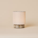 Dou Small Silver Travertine Rechargeable Table Lamp with a cream linen shade on a neutral studio backdrop
