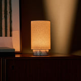 Lampe de table Floris marbre Arabescato sans fil Tavellio - gros plan sur meuble en bois - lumiere tamisee devant des stores a lattes
