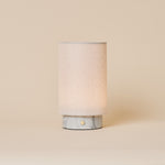 Floris rechargeable table lamp with white Bianco Statuarietto marble base on a cream studio backdrop