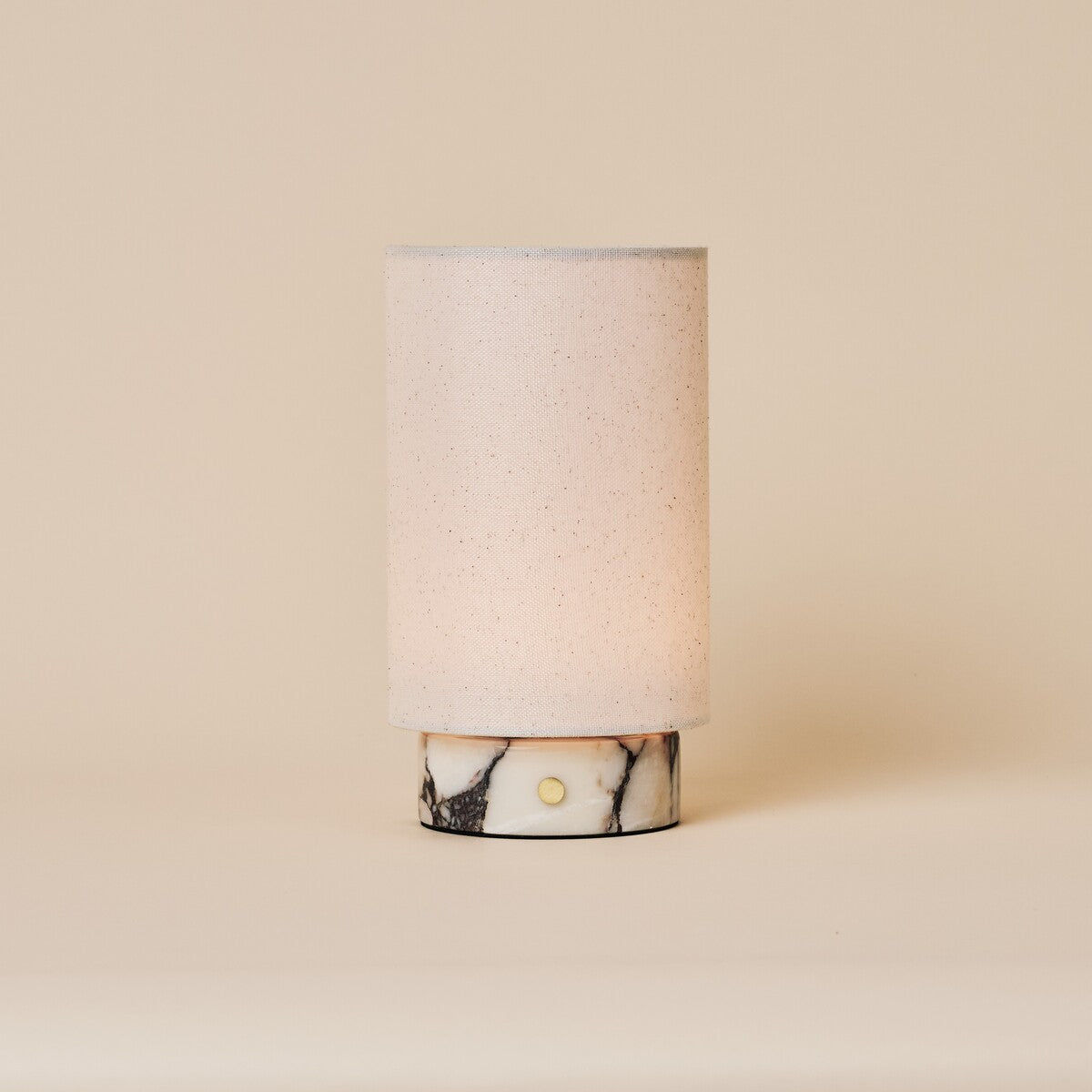 Floris cordless table lamp in Calacatta Vionaro white marble with linen shade on a soft studio background