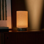 Tavellio Floris rechargeable table lamp in Ice Green marble glowing on a sideboard against a warm lit wall