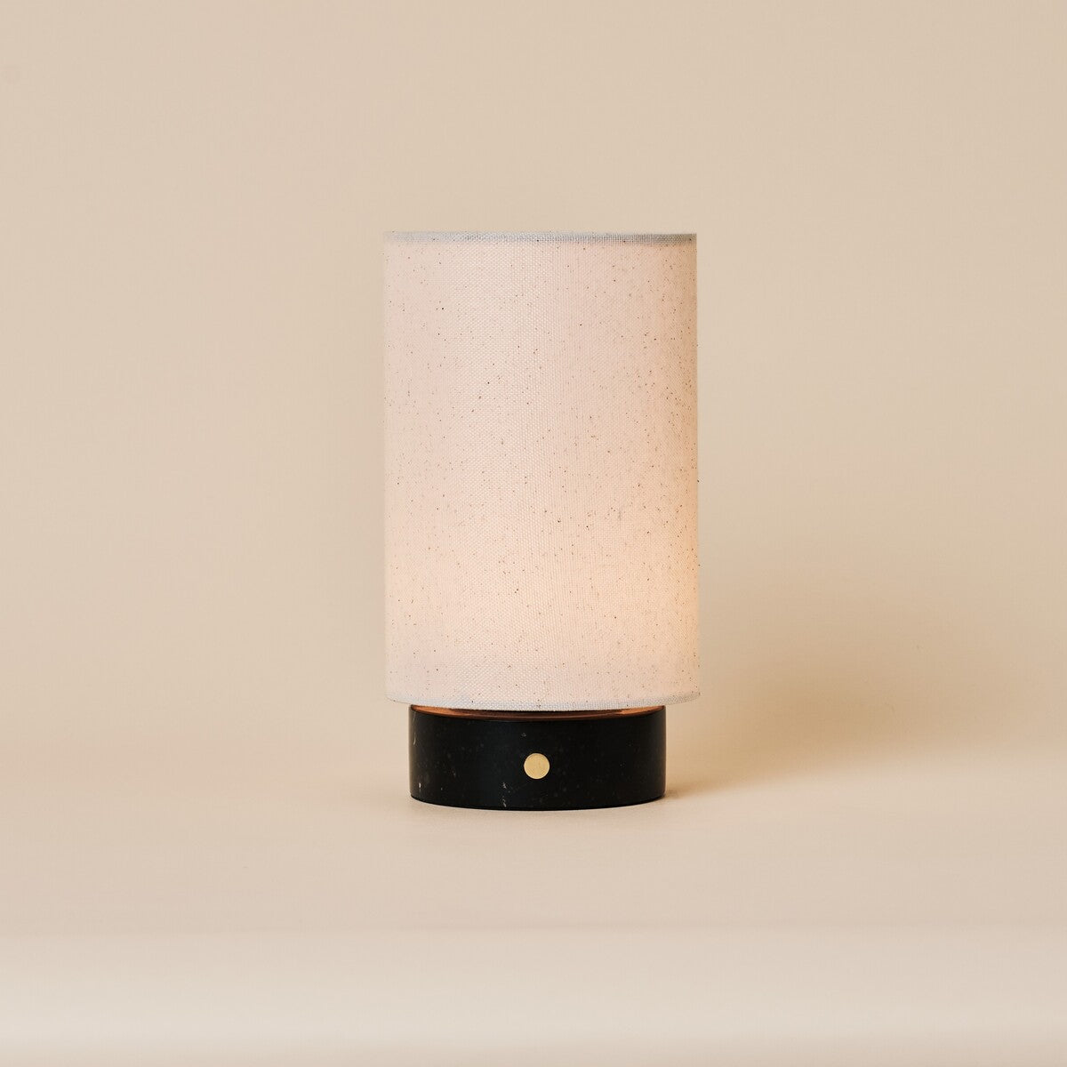 Floris Nero Marquina rechargeable table lamp with black marble base and linen shade on neutral background