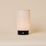 Floris Nero Marquina rechargeable table lamp with black marble base and linen shade on neutral background