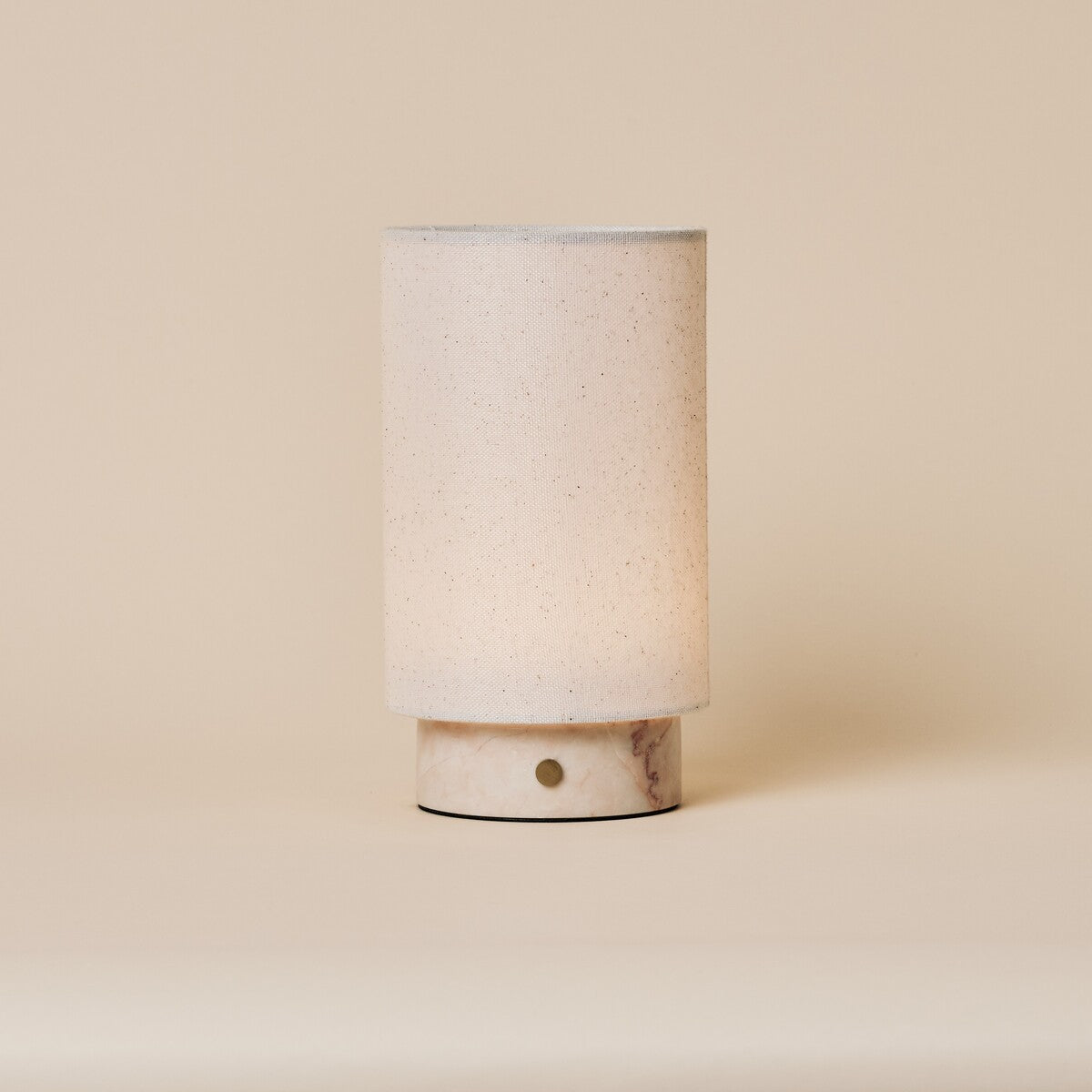 Floris cordless table lamp with pale Rosa Aurora marble base, linen shade on a soft cream backdrop