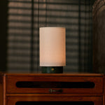 Floris Verde Alpi Marble cordless table lamp on a vintage wood dresser with blind-shadow light