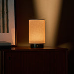 Tavellio Floris Verde Alpi Marble rechargeable table lamp glowing warmly against a lit wall