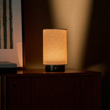 Tavellio Floris Verde Alpi Marble rechargeable table lamp glowing warmly against a lit wall