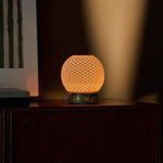 Mare rechargeable table lamp with yellow marble base under a warm spotlight beam