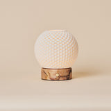 Cordless table lamp showing the dimpled porcelain shade and pink marble base on a plain background