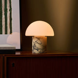 Cordless table lamp featuring dramatic dark veining in a warm gold marble lamp base