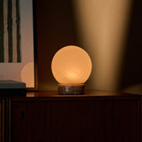 Rechargeable table lamp Metsu Small in Calacatta Vionaro pink marble on a bedside cabinet