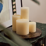 Emperador Dark marble tray styled with pillar candles atop a green marble side table