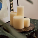 Emperador Dark marble tray styled with pillar candles atop a green marble side table